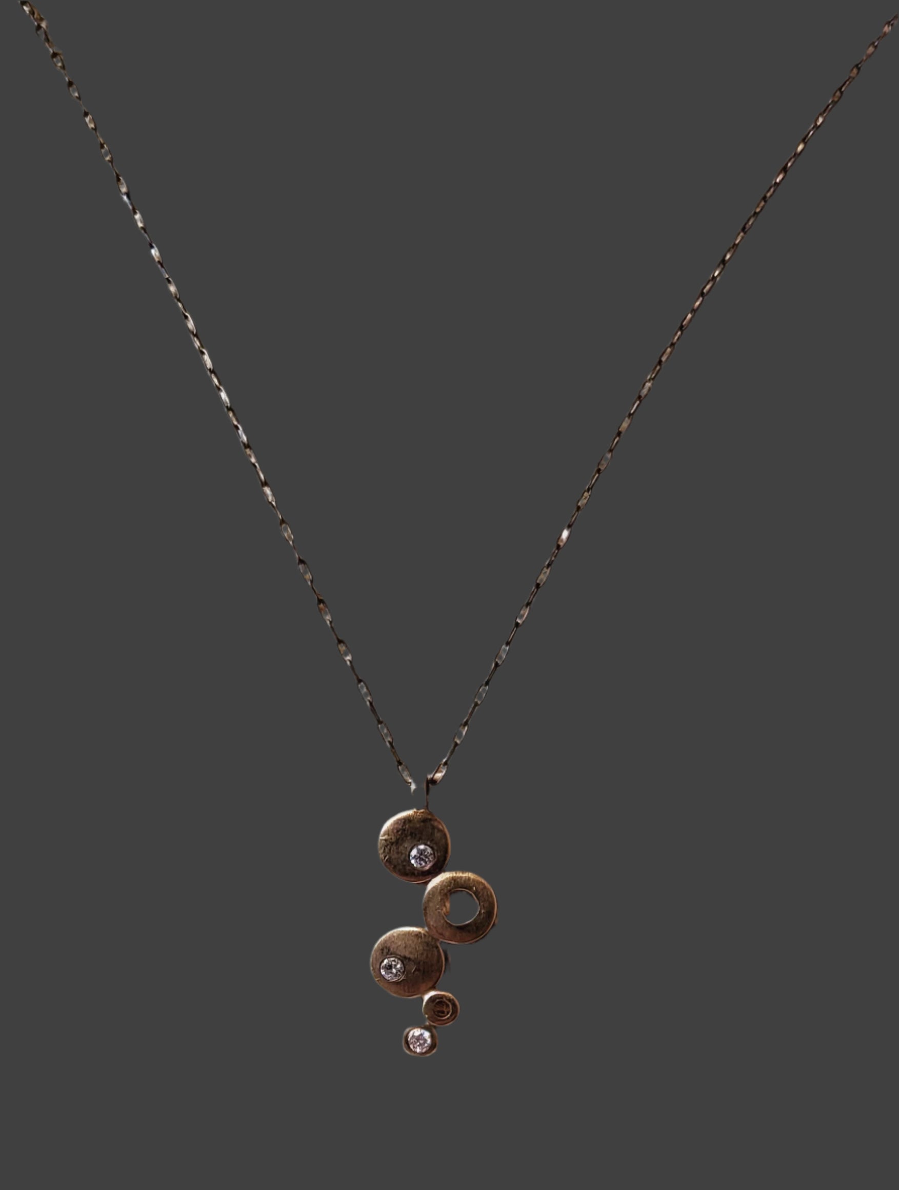 Gold and Diamond graduated disc pendant