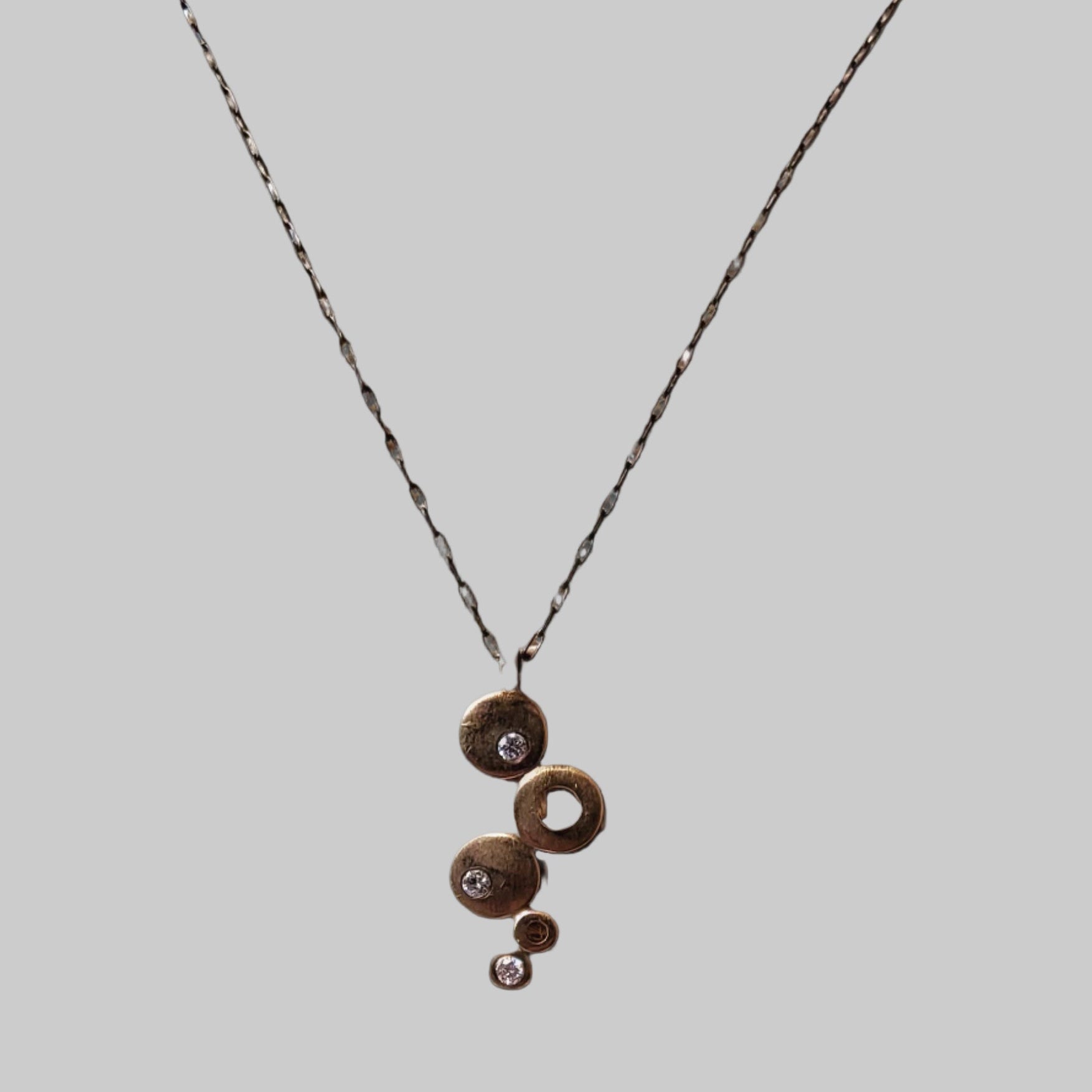 Gold and Diamond graduated disc pendant