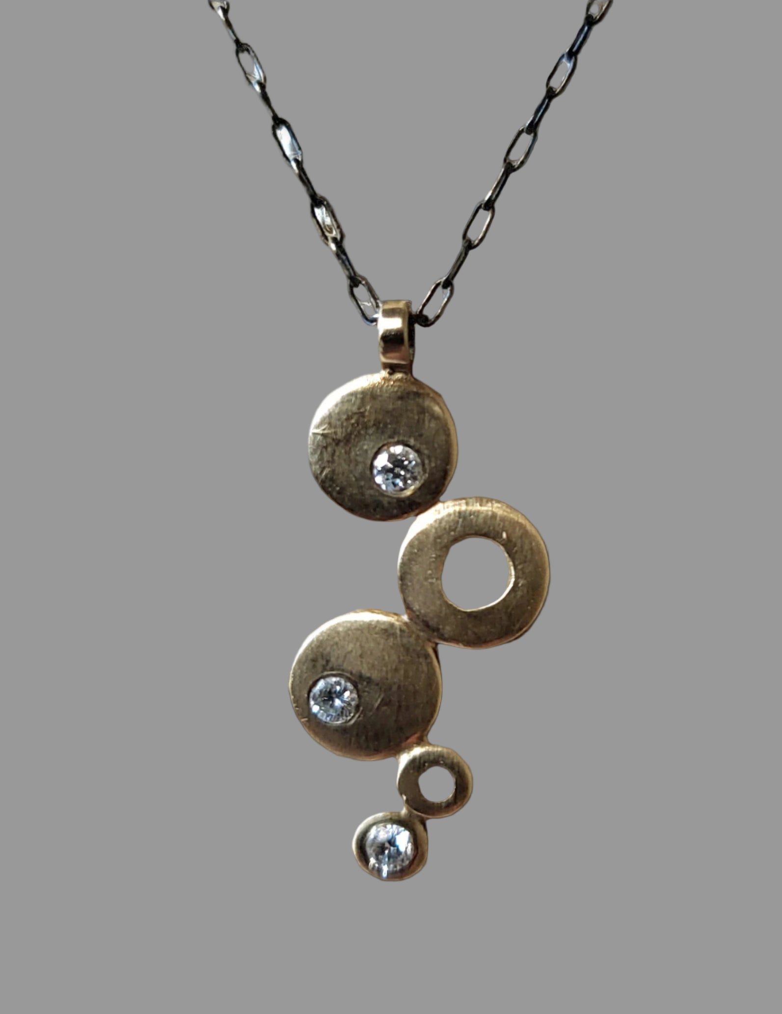 Gold and Diamond graduated disc pendant